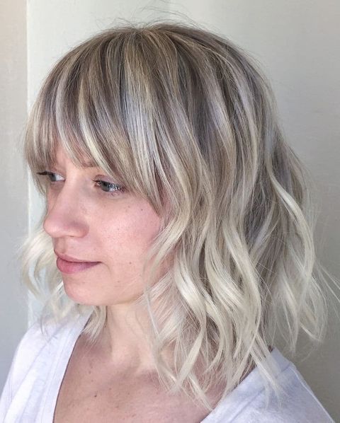 Balayage blonde waves with bangs