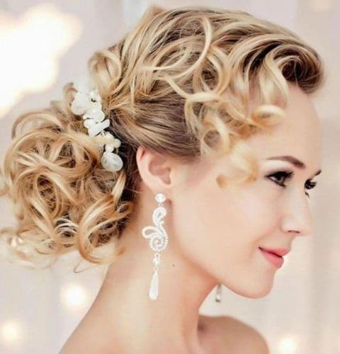 Curly bun wedding hairstyle 2021-2022