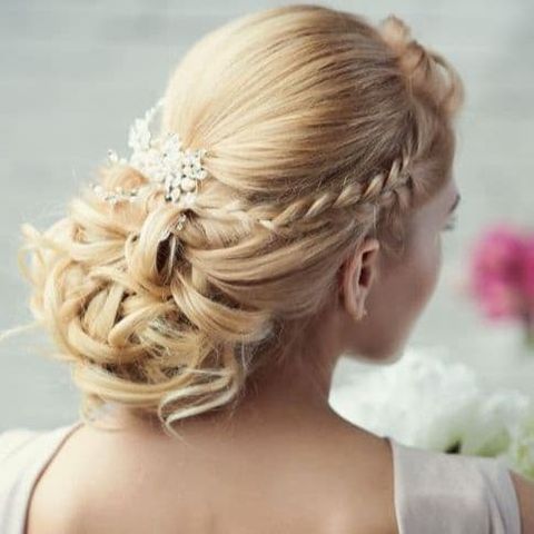 Side braided low bun wedding hairstyle 2021-2022