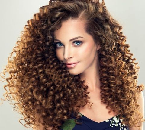 Side swept curly long hair for women in 2021-2022