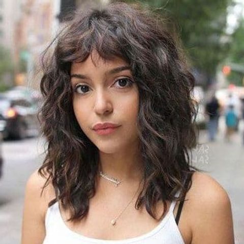 Curly mid-length hairstyle with bangs 2021-2022