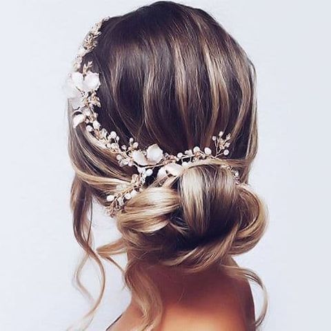 Low bun hairstyle with flowers for women in 2021-2022
