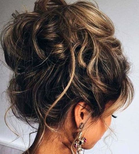 Messy high bun for prom hairstyles for women in 2021-2022