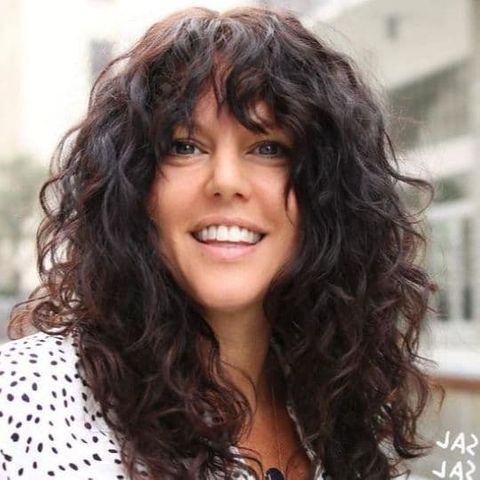 Curly long hair with bangs for women in 2021-2022