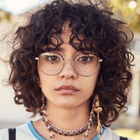 Curly bob haircut with bangs for women in 2021-2022
