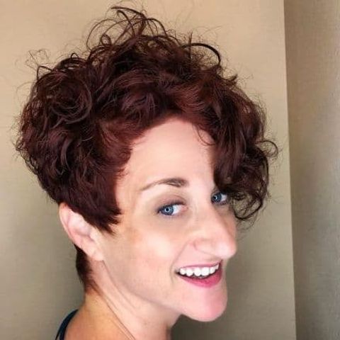 Curly pixie cut with bangs for long faces