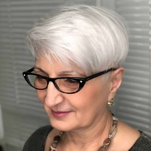 Blonde fine short hairstyle for women over 60 with glasses