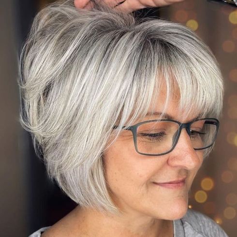 Layered short bob for women over 60 with glasses