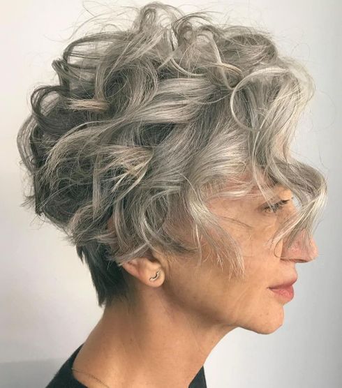 Pixie curly haircut with bangs for women over 60