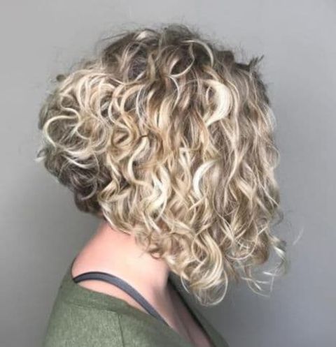 Blonde balayage asymmetrical curly long bob haircut