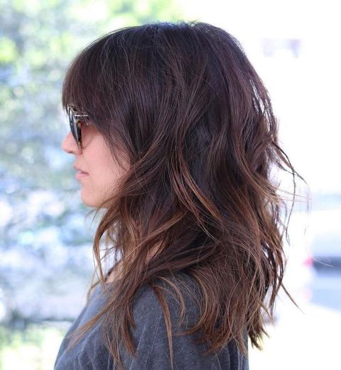 Wavy brown balayage with bangs