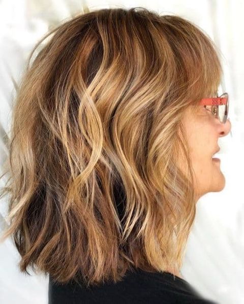 Wavy brown hair color mid-length hair with bangs 2021-2022