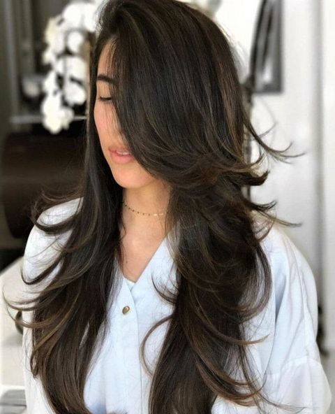 Side parted wavy long layered hair
