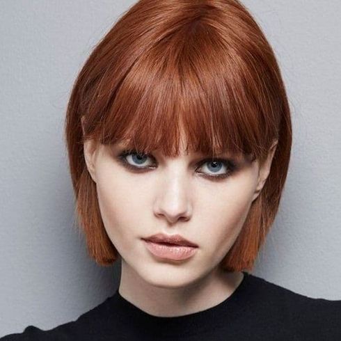 Red short bob cut with bangs for square faces