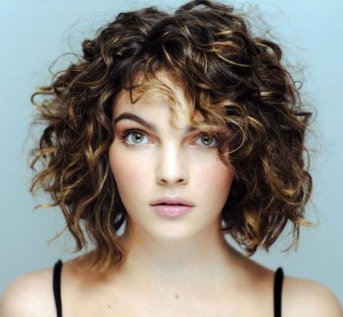 Center parted balayage short curly bob